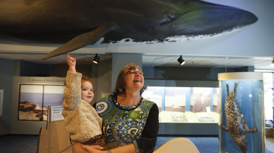 A women holds a toddler in the Marine Gallery